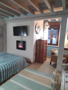 a bedroom with a bed and a fireplace at Más Quimera in Gilgarcía