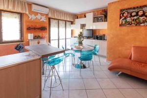 a kitchen with a table and some blue chairs at Il Dolce Risveglio in Fossacesia