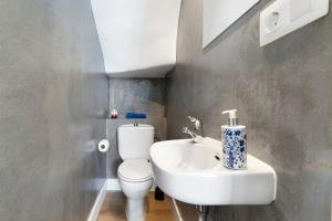 a bathroom with a white toilet and a sink at Bungalow Green Oasis in San Bartolomé +14 photos