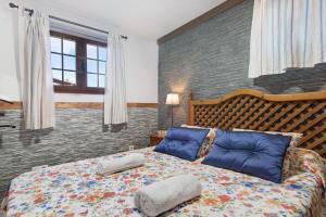 a bedroom with a bed with two pillows on it at La Casita de Vals in Valsequillo +13 photos