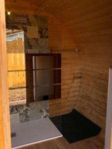 a kitchen in a wooden cabin with a refrigerator at Barrel Orange in Saint-André +15 photos
