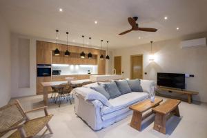a living room with a white couch and a table at Villa Alexandra in Lefkada