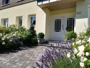 a front door of a house with flowers at Ferienwohnungen Ambiente-Schmidt in Olsberg
