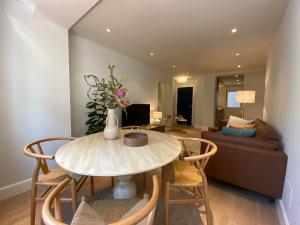 a living room with a table and chairs and a couch at 'Socaire' Ribadesella in Ribadesella +36 photos