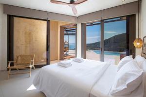 a bedroom with a bed and a view of the ocean at Villa Alexandra in Lefkada +38 photos