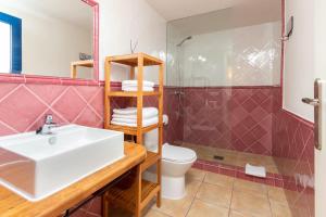 a bathroom with a sink and a toilet and a shower at Mas Tinus - Palmera in Santa Cristina d'Aro +6 photos
