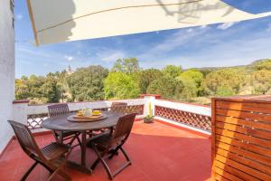 a patio with a table and chairs on a balcony at Mas Tinus - Palmera in Santa Cristina d'Aro