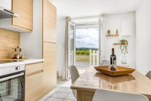 a kitchen with a table with wine glasses on it at Gite Barrail du Moulin in Bégadan