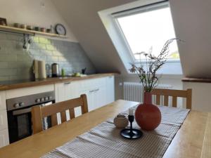 a kitchen with a table with a vase on it at Gullerhof Ferienwohnung - Köpfle in Glottertal
