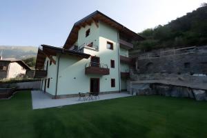 a white house with a green lawn in front of it at Appartamenti Suly 4 - Cir0085 in Saint Vincent