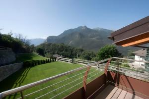 a balcony with a view of a lawn and mountains at Appartamenti Suly 4 - Cir0085 in Saint Vincent +2 photos