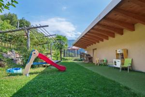 a backyard with a playground with a slide at Pfösslerhof in Bolzano