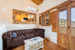 a living room with a brown couch and a table at El Kubo in Olba