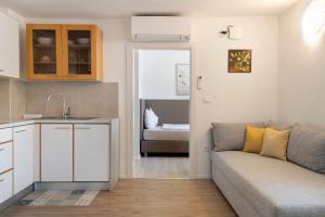 a living room with a couch and a kitchen at Auelehof Laives in Laives