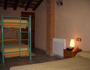 a bedroom with a bunk bed and a lamp at Casa Gimeno in Bocairent