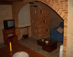 a living room with a bed and a tv at Casa Gimeno in Bocairent