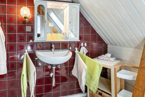 a bathroom with a sink and a mirror at La Rose in Tengen +18 photos