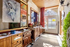 a kitchen with wooden cabinets and a large window at La Rose in Tengen