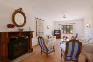 a living room with a fireplace and a mirror at Sa Corbaia Nova in Artá
