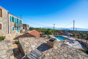 a villa with a swimming pool and a building at Milia's House Ithaca in Vathi