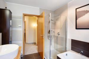 a bathroom with a shower and a sink at Fewo am Hennesee in Meschede +14 photos