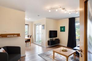 a living room with a couch and a table at Fewo am Hennesee in Meschede