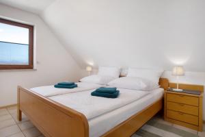 a bedroom with a bed with two green pillows on it at Gästehaus Heinemann - Dg4 in Langenargen