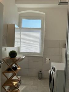 a small bathroom with a sink and a window at Harzträume Thale in Thale