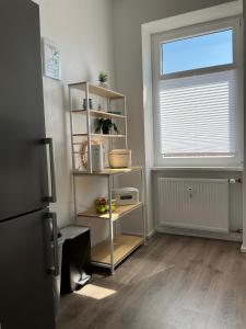 a room with a book shelf and a window at Harzträume Thale in Thale