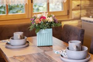 a vase of flowers sitting on top of a table at Chalet am See - Vogtland Chalet in Bad Brambach +17 photos