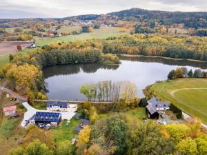 an aerial view of a house next to a lake at Chalet am See - Vogtland Chalet in Bad Brambach