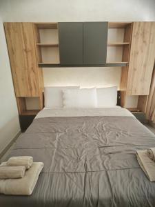 a bedroom with a bed with two towels on it at DeMarchi in Biella