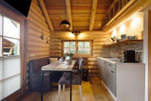 a kitchen with a table in a log cabin at Chalet am See - Vogtland Chalet in Bad Brambach
