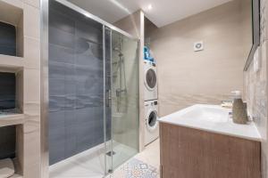 a bathroom with a shower and a sink and a washing machine at Petit Palau in Port de Soller +17 photos