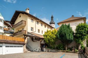 a large house with a garage in front of it at Haus Thurn Apartment B in Castelrotto