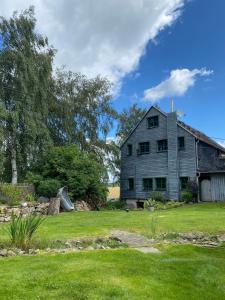 an old barn with a slide in a yard at Ferienwohnung Dina in Olbernhau
