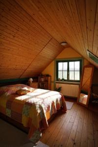 a bedroom with a bed and a wooden ceiling at Ferienwohnung Dina in Olbernhau