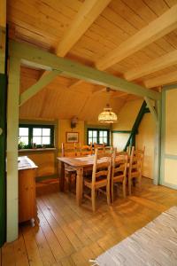 a wooden dining room with a table and chairs at Ferienwohnung Dina in Olbernhau +18 photos
