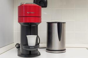 a red blender sitting on top of a counter at Villa Marconi Apartment 5 in Golfo Aranci