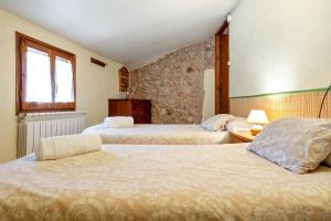 a bedroom with two beds and a window at Cal Marti in Farena +5 photos