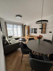 a living room with a couch and a table at Sofia Tech Park Apartments - Premium in Sofia