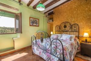 a bedroom with a iron bed in a room with a window at El Torrent in Pinell de Solsones +24 photos