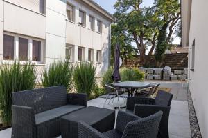 a patio with a table and chairs and an umbrella at Ferienwohnung Seeglück in Moos