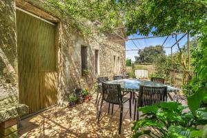 a patio with a table and chairs and a pool at El Torrent in Pinell de Solsones