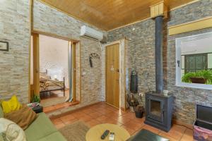 a living room with a couch and a fireplace at Casa Rosi Cave House in Artenara