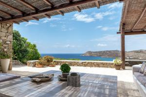 a view of the ocean from the patio of a villa at Calma Beach House in Elia Beach