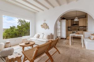 a living room with a couch and a table at Calma Beach House in Elia Beach