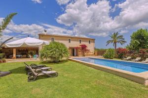 a villa with a swimming pool and a house at Finca Antonio in Búger