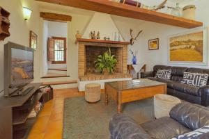 a living room with a couch and a fireplace at Finca Antonio in Búger