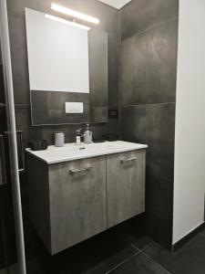 a bathroom with a sink and a mirror at DeMarchi in Biella +17 photos